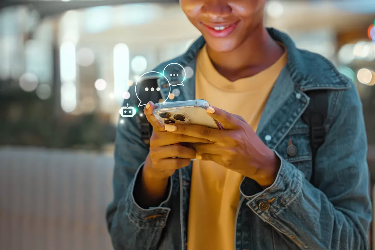 Woman wearing a yellow shirt talking to a chatbot