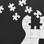 Puzzle pieces forming a human head, representing the concept of memory in AI agents.