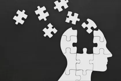 Puzzle pieces forming a human head, representing the concept of memory in AI agents.